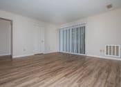 Thumbnail 24 of 27 - A room with wooden flooring and white walls.