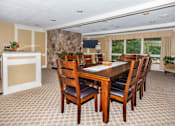 Thumbnail 8 of 27 - A dining room with a table and chairs.