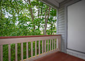 Thumbnail 26 of 27 - A white door is on the right side of a porch.