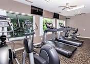 Thumbnail 6 of 20 - A spacious gym with treadmills, elliptical machines, and exercise bikes. at North Pointe Apartments, Clifton Park, NY