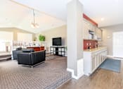 Thumbnail 13 of 20 - A living room with a black sofa and a television. at North Pointe Apartments, Clifton Park, NY, 12065