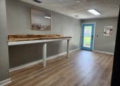 Thumbnail 32 of 32 - an empty room with a table in the center of it at The Fountains at Deerwood, Jacksonville, FL, 32256