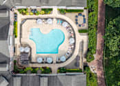 Thumbnail 1 of 31 - A large swimming pool surrounded by lounge chairs and umbrellas.