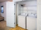 Thumbnail 10 of 27 - a washer and dryer in a room with a closetat Merion Stratford Apartment Homes, Connecticut