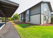 Thumbnail 25 of 28 - a view of the outside of the building with a paved walkway and grassy area