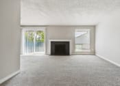 Thumbnail 4 of 28 - an empty living room with a fireplace