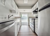 Thumbnail 9 of 28 - a kitchen with white cabinets and stainless steel appliances