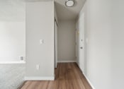 Thumbnail 11 of 28 - a hallway with hardwood floors and white walls