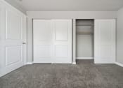 Thumbnail 14 of 28 - an empty bedroom with two doors and a closet
