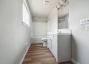 Thumbnail 17 of 28 - a bathroom with a toilet sink mirror and shower in a 555 waverly unit