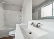 Thumbnail 19 of 28 - a bathroom with a toilet sink and bathtub