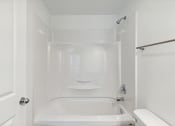 Thumbnail 12 of 41 - a bathroom with a shower and a sink and a bath tub