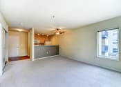 Thumbnail 9 of 22 - the living room and kitchen of an empty house with a ceiling fan