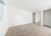 Thumbnail 29 of 41 - a room with carpet and white walls and sliding glass doors
