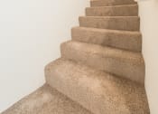 Thumbnail 21 of 41 - an image of a carpeted staircase in a home with white walls