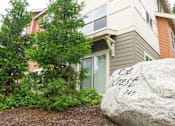 Thumbnail 1 of 33 - A large rock with the words "Cob West 341" written on it in front of a house.