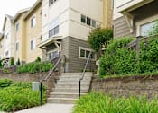 Thumbnail 2 of 33 - A staircase with a railing leads up to a building.