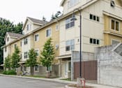Thumbnail 5 of 33 - Apartment building with a bicycle parked in front.