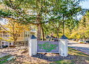 Thumbnail 1 of 24 - A sign that says "Hillcrest Gardens" is in front of a tree.