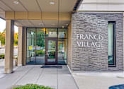 Thumbnail 5 of 27 - The front of a building with the name "Francis Village" on it.