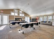 Thumbnail 16 of 24 - A conference room with a long table and chairs.
