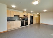 Thumbnail 12 of 22 - A kitchen with a black dishwasher and black refrigerator.