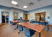 Thumbnail 11 of 27 - A conference room with a long table and chairs.