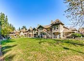 Thumbnail 11 of 24 - A row of houses with a green lawn in front.