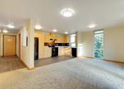 Thumbnail 19 of 22 - A spacious kitchen with a refrigerator, oven, and sink.