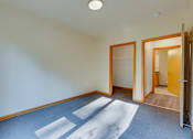 Thumbnail 25 of 27 - A room with a blue carpet and white walls.