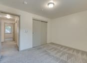 Thumbnail 33 of 33 - A room with a carpeted floor and a ceiling light.