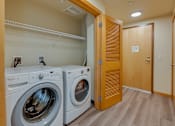 Thumbnail 23 of 27 - A laundry room with a washer and dryer.