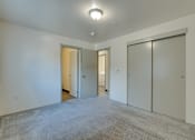 Thumbnail 24 of 33 - A room with a carpeted floor and three doors.