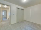 Thumbnail 23 of 33 - A room with a carpeted floor and a sliding door.