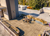 Thumbnail 7 of 27 - A patio area with a table and chairs.