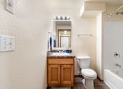 Thumbnail 9 of 29 - A bathroom with a toilet, sink, and bathtub.