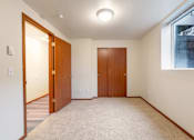 Thumbnail 12 of 29 - A room with two doors and a window.