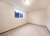 Thumbnail 17 of 29 - A room with a window and carpeted floor.