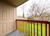 Thumbnail 14 of 29 - A view from a balcony looking out to a yard.