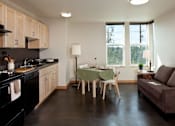 Thumbnail 1 of 22 - A kitchen with a table and chairs in the middle of the room.