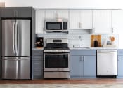 Thumbnail 13 of 34 - a kitchen with stainless steel appliances and white cabinets
