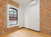 Thumbnail 5 of 22 - an empty room with a brick wall and a window