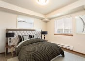 Thumbnail 5 of 14 - a bedroom with a bed and two windows