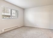 Thumbnail 28 of 40 - a bedroom with a carpeted floor and a large window