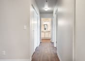 Thumbnail 26 of 40 - a hallway with wood floors and white walls