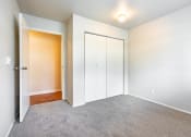 Thumbnail 32 of 40 - a bedroom with white walls and gray carpet
