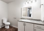 Thumbnail 33 of 40 - a bathroom with a toilet sink and mirror