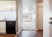 Thumbnail 18 of 40 - a kitchen with white cabinets and a black dishwasher