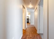 Thumbnail 20 of 40 - a hallway with wood floors and white walls