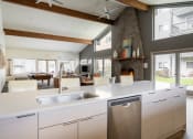 Thumbnail 7 of 40 - a kitchen with a large center island next to a living room with a pool table and a